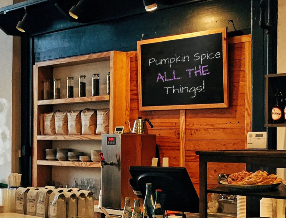 photograph of coffee shop with menu board labeled "pumpkin spice all the things"